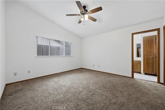 an empty room with fan and windows