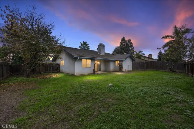 a front view of a house with yard and green space