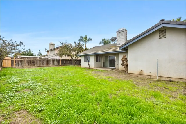 a view of a house with a yard and sitting area