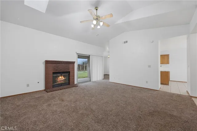 a view of an empty room with a fireplace