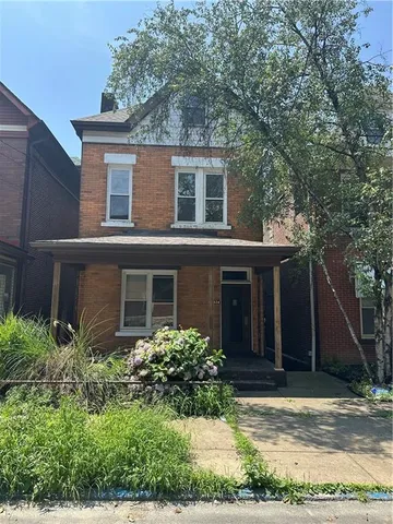 a view of house with yard