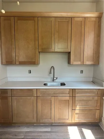 a sink with a white cabinets