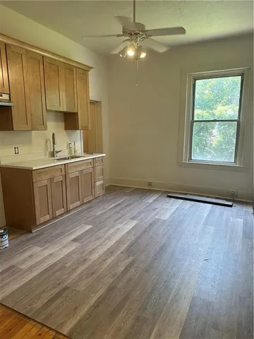 a view of a kitchen with a sink cabinets and wooden floor