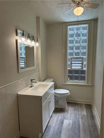 a kitchen with stainless steel appliances granite countertop a sink a stove and a wooden floors