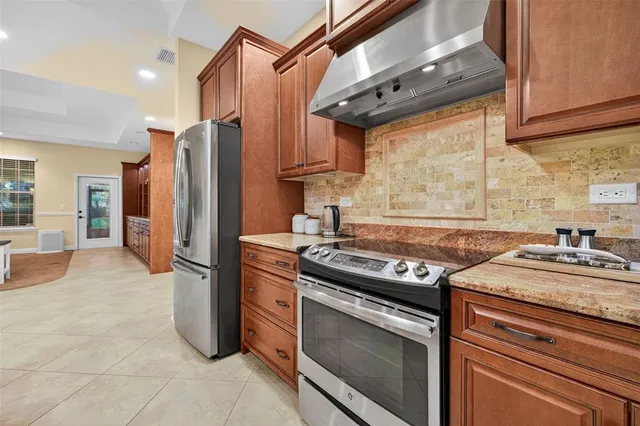 a kitchen with a stove a refrigerator and a sink