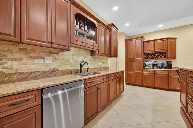 a kitchen with stainless steel appliances granite countertop a sink and cabinets