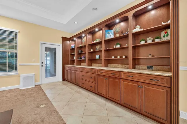 a kitchen with granite countertop a sink and cabinets