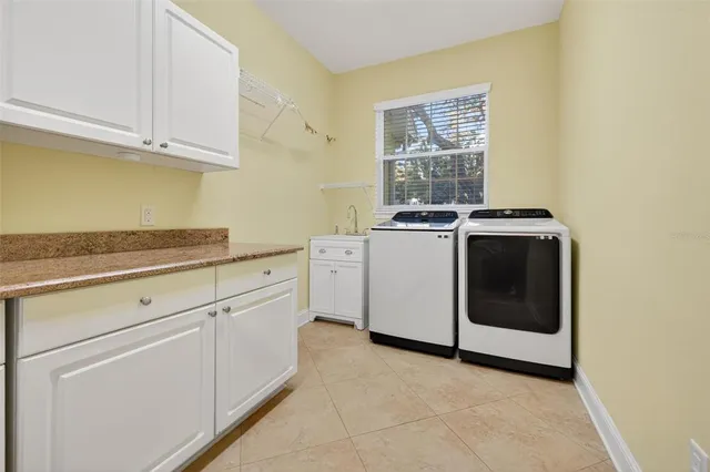 a kitchen with a stove sink and cabinets