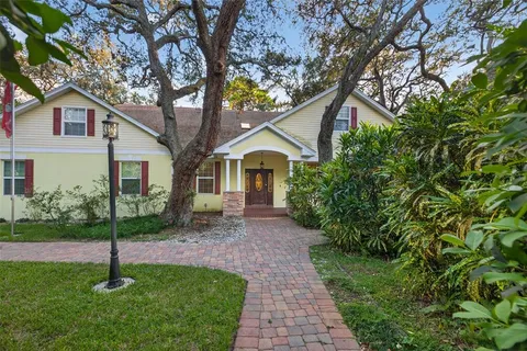 a front view of a house with a garden