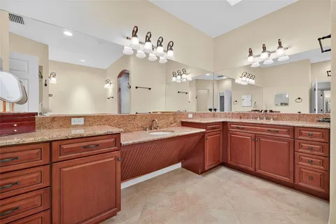 a spacious bathroom with a granite countertop double vanity sink mirror and