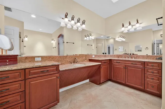 a spacious bathroom with a granite countertop double vanity sink mirror and