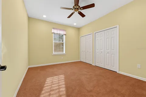 a view of empty room with ceiling fan