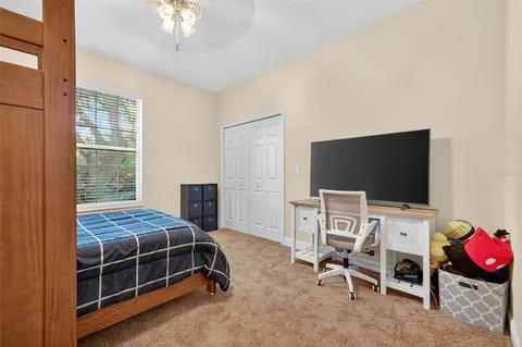a bedroom with bed and flat screen tv