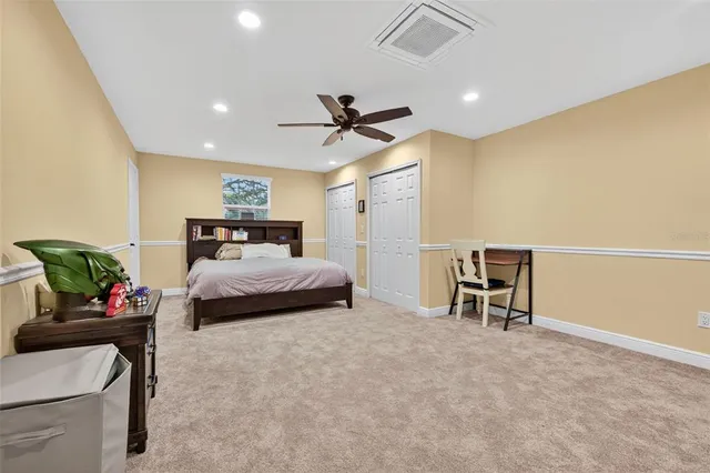 a bedroom with furniture and a ceiling fan