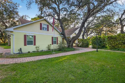 a view of a house with a backyard