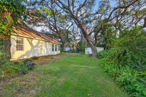a view of a yard with a house and a tree