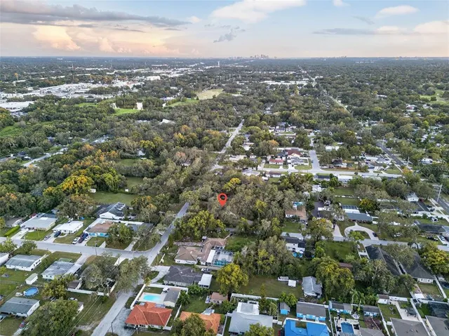 an aerial view of residential houses with city view