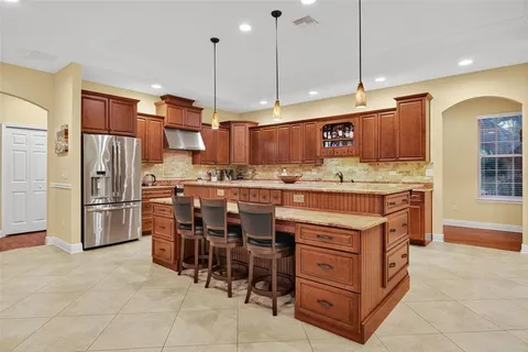 a kitchen with a refrigerator a oven and a sink