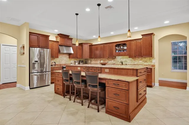 a kitchen with a refrigerator a oven and a sink