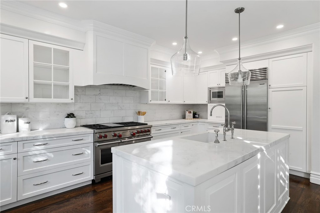 18 Lyon Newport Coast, CA 92657 - Photo 13 of 55 a kitchen with stainless steel appliances kitchen island granite countertop a sink a stove and a refrigerator