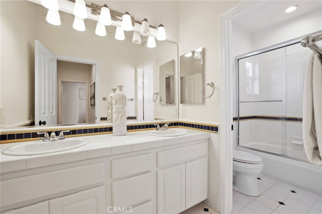 18 Lyon Newport Coast, CA 92657 - Photo 38 of 55 a bathroom with a granite countertop sink a toilet a mirror and shower