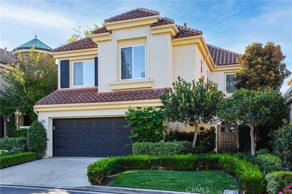 18 Lyon Newport Coast, CA 92657 - Photo 4 of 55 a front view of a house with a yard and garage