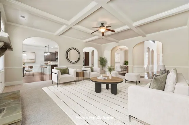 a kitchen with stainless steel appliances kitchen island granite countertop a stove a sink and a wooden floor