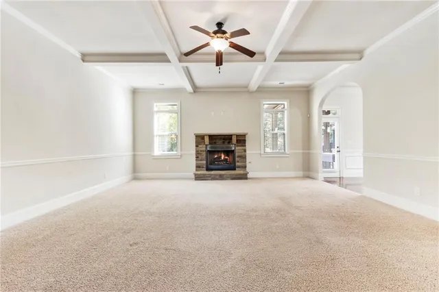 a large kitchen with granite countertop a large kitchen island in the center and stainless steel appliances