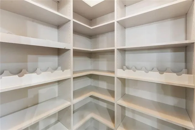 a living room with furniture a large window and a fireplace