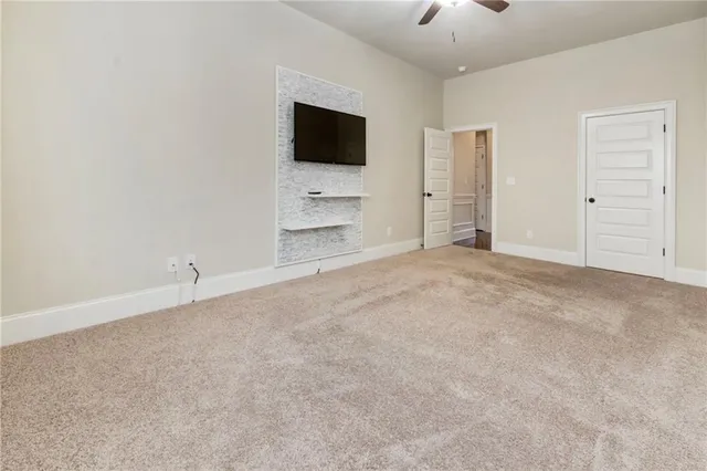 a view of a hallway with furniture and a chandelier