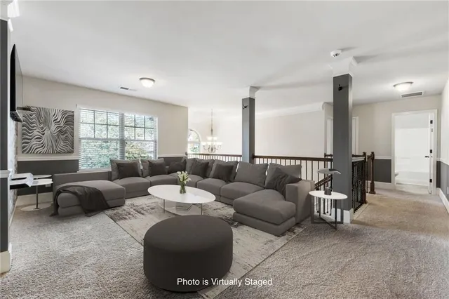 a living room with furniture and a clock