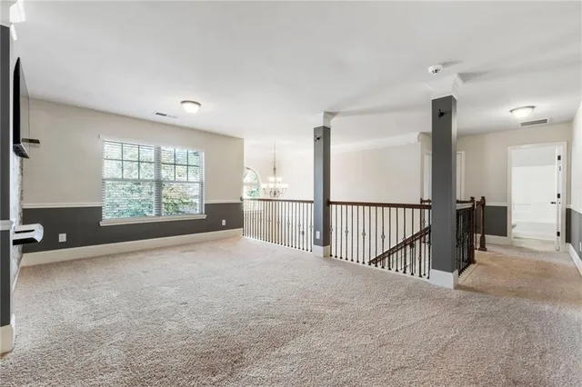 a view of a big room with closet and windows