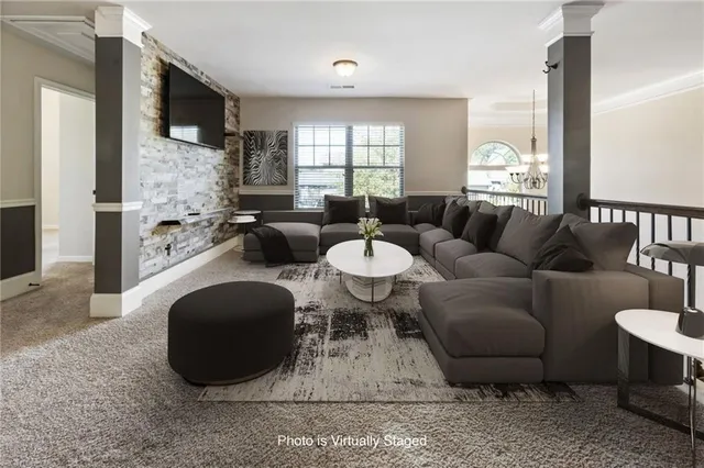 a view of a hallway to a livingroom with wooden floor a fireplace and a hallway