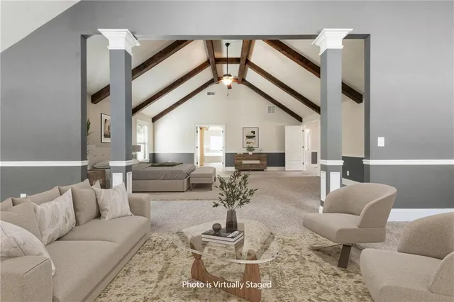 a view of an empty room and wooden floor and cabinets
