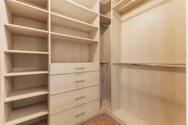 a living room with furniture a large window and wooden floor