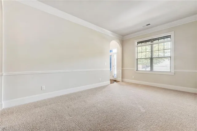 a view of a dining room with furniture and a potted plant