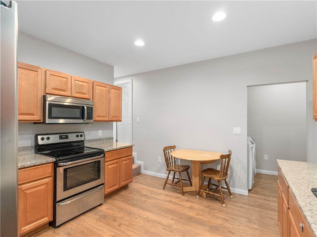 2031 Monroeville Road Monroeville, PA 15146 - Photo 15 of 25 a kitchen with stainless steel appliances a stove a sink cabinets and a dining table
