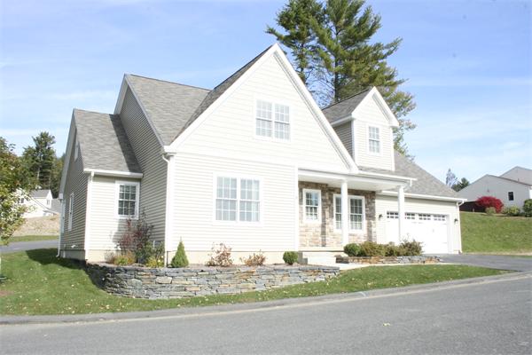 20 Bridge Road, Unit 31 Northampton, MA 01062 - Photo 1 of 1 a view of a white house next to a yard and large trees