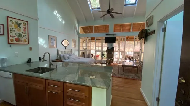a kitchen with stainless steel appliances granite countertop a sink a stove and cabinets