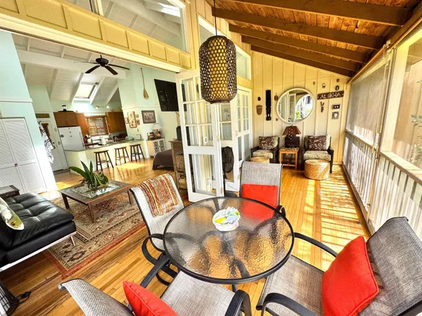 an aerial view of a house with a garden and lake view