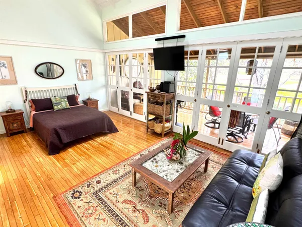 a living room with a couch and a wooden floor