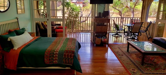 a living room with furniture fireplace and wooden floor