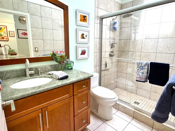 a spacious bedroom with a bed a couch and a window