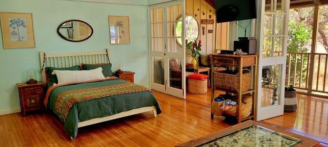 a bedroom with a bed a mirror and dresser