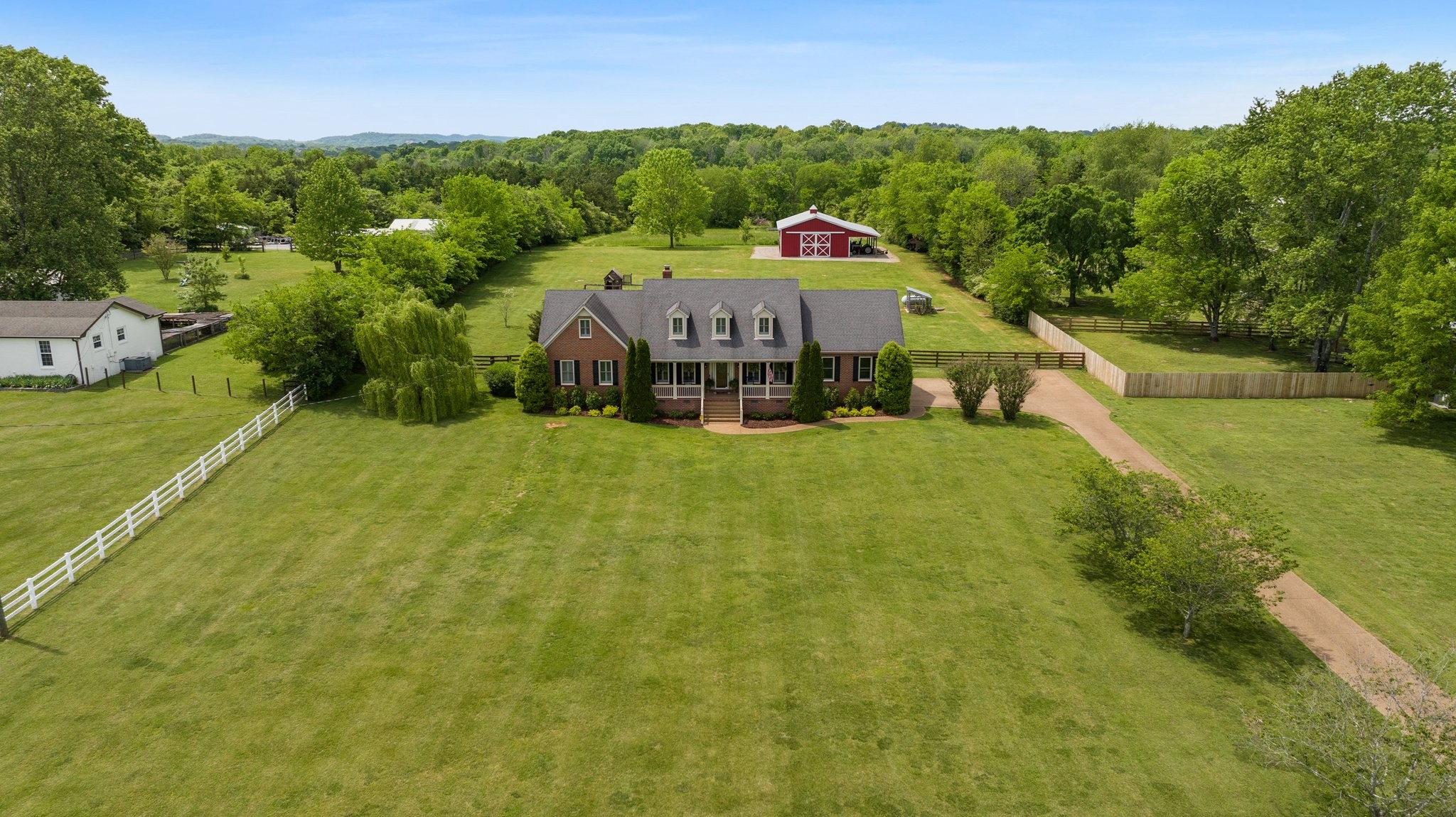 6223 Ladd Road Franklin, TN 37067 - Photo 1 of 67 a view of a big yard with potted plants and large trees