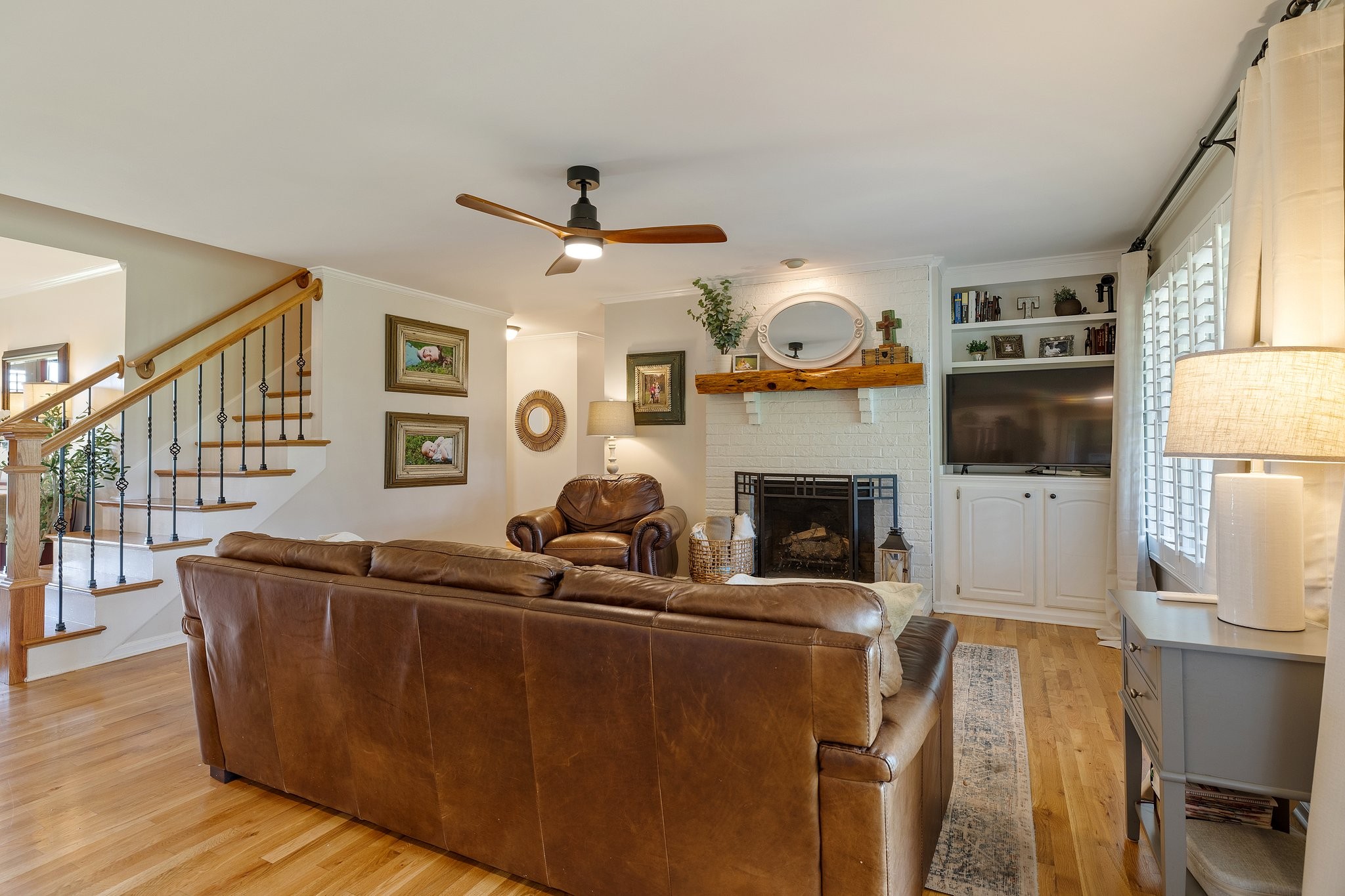 6223 Ladd Road Franklin, TN 37067 - Photo 19 of 67 a living room with furniture a fireplace and a flat screen tv