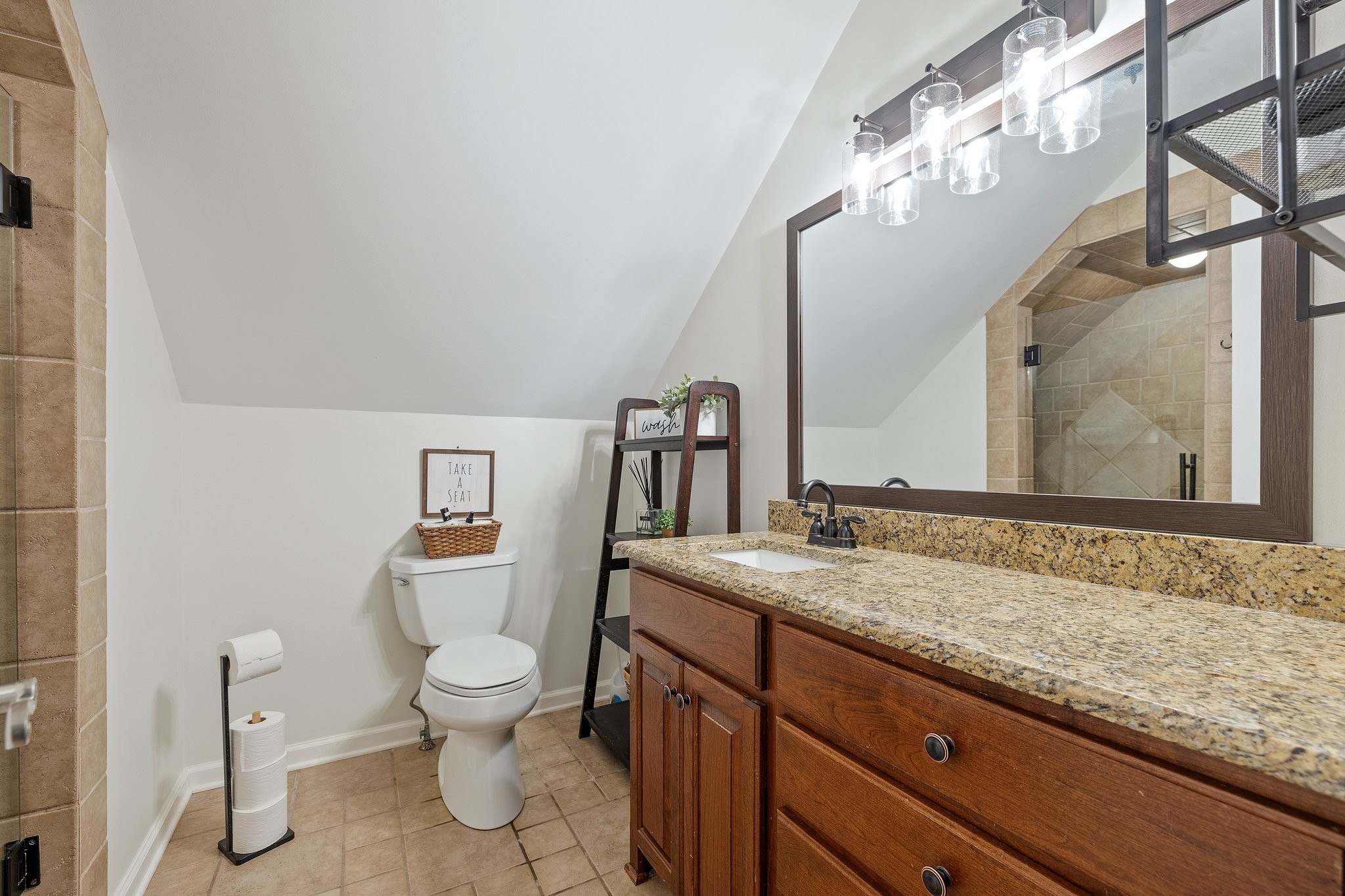 6223 Ladd Road Franklin, TN 37067 - Photo 41 of 67 a bathroom with a granite countertop sink a toilet and a mirror