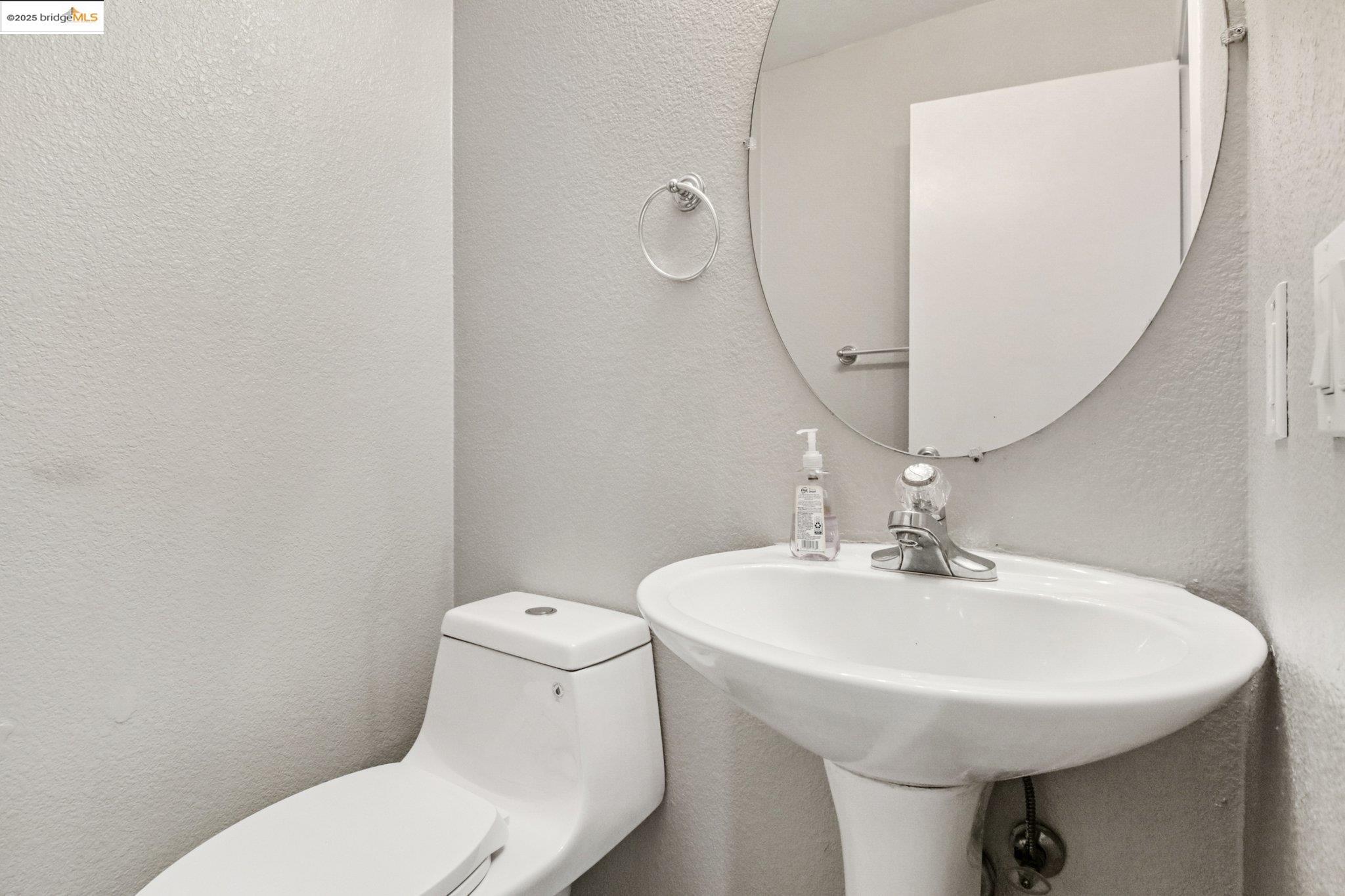 1559 Freed Circle Pittsburg, CA 94565 - Photo 15 of 32 a bathroom with a sink a toilet and mirror