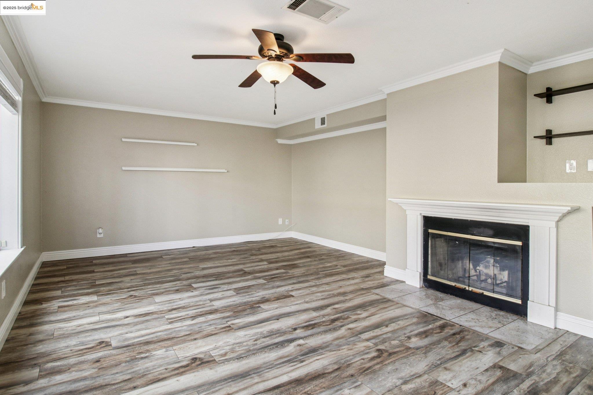 1559 Freed Circle Pittsburg, CA 94565 - Photo 9 of 32 a view of empty room with fireplace and fan