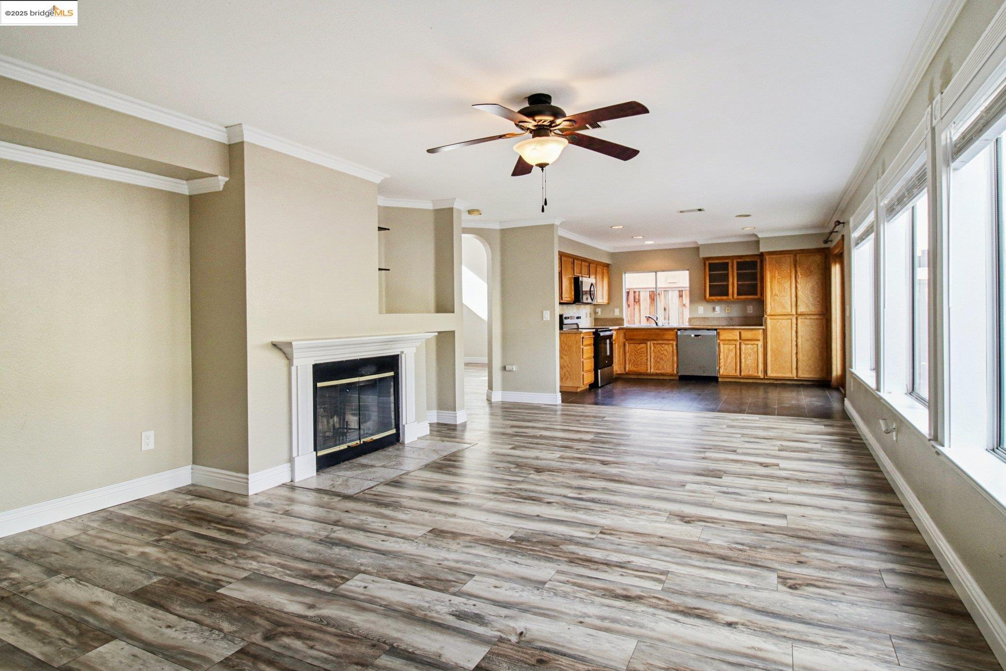 1559 Freed Circle Pittsburg, CA 94565 - Photo 10 of 32 a view of a livingroom with wooden floor and a ceiling fan